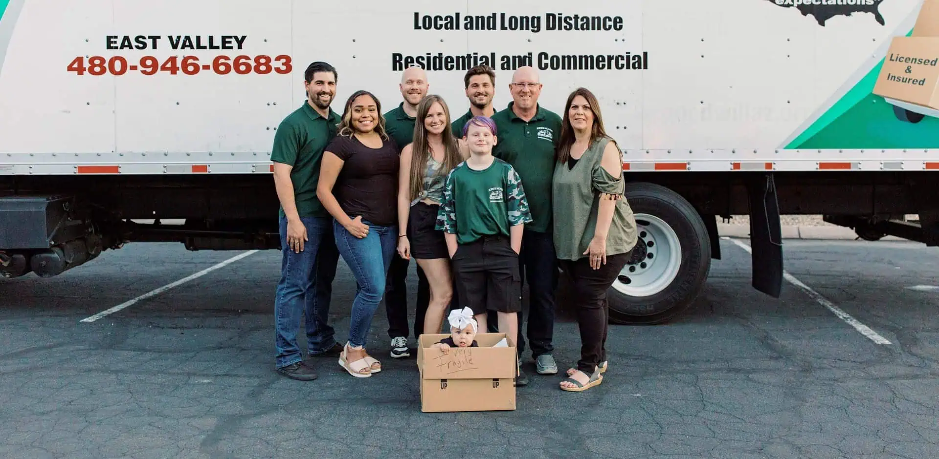 Jones Moving & Storage family and crew in front of a moving truck
